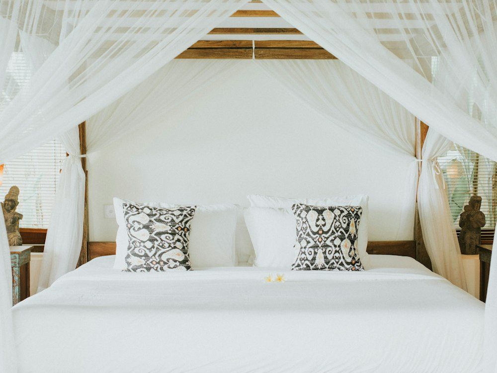 A bedroom prepared with fresh white linens